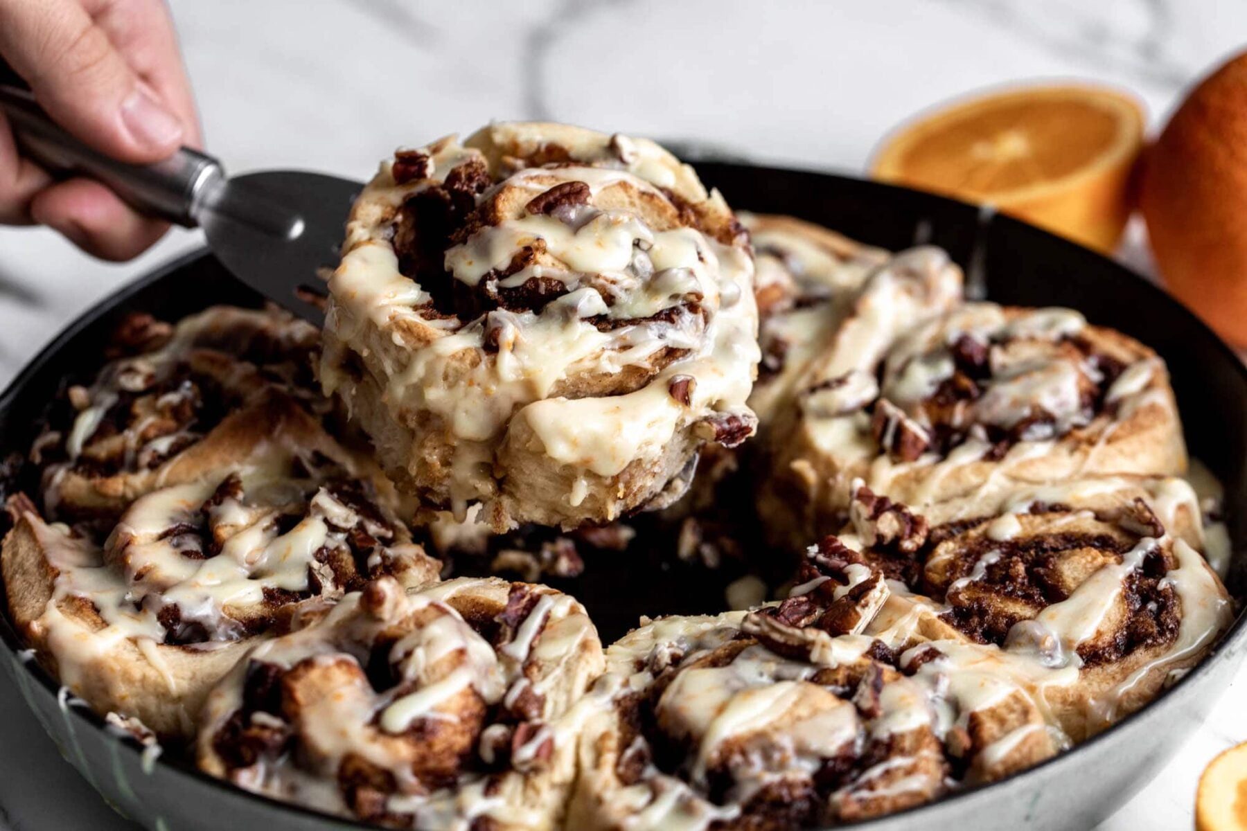 Orange Rolls with Pecans recipe in staub cast iron pan.