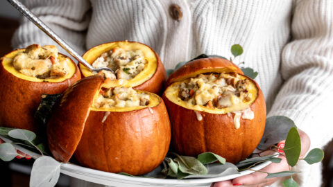 Ground Turkey and Brown Butter Stuffed Pumpkins on white platter garnished with sage and eucalyptus