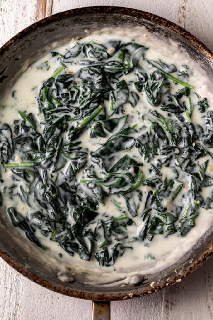 creamed spinach in a sauté pan.