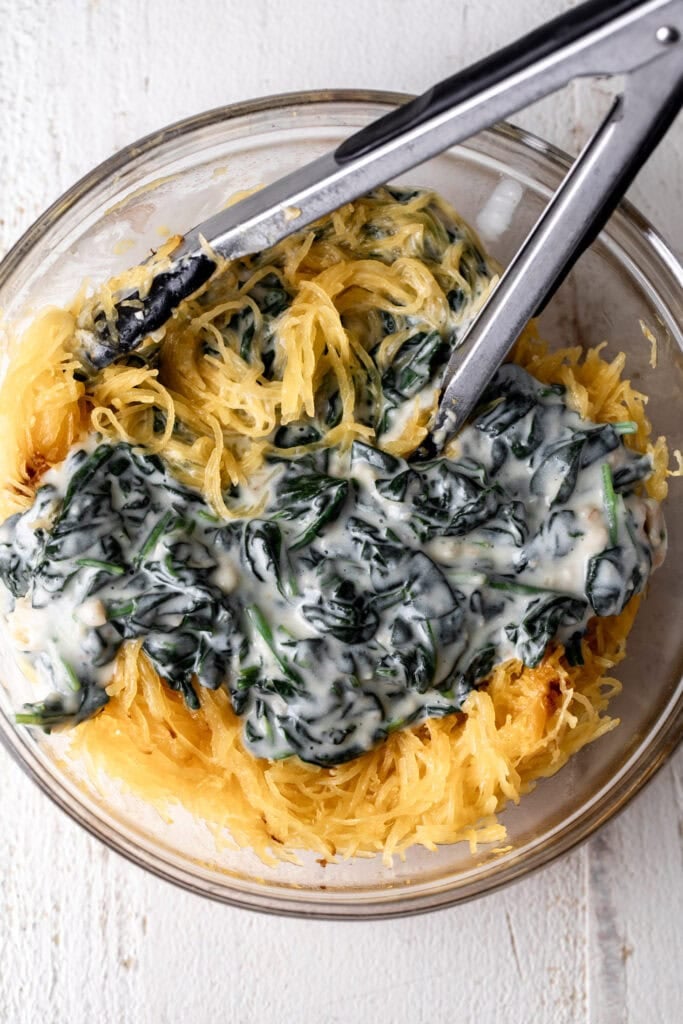 creamed spinach and spaghetti squash in mixing bowl.