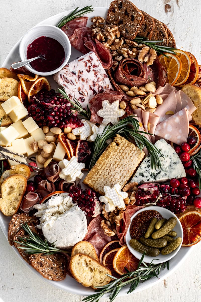 festive holiday cheese board with assorted cheese and charcuterie.