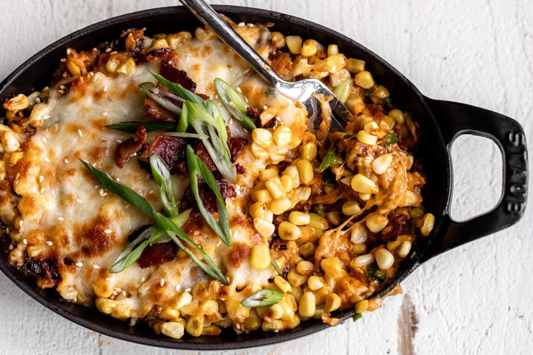 Korean corn cheese with bacon and scallions.
