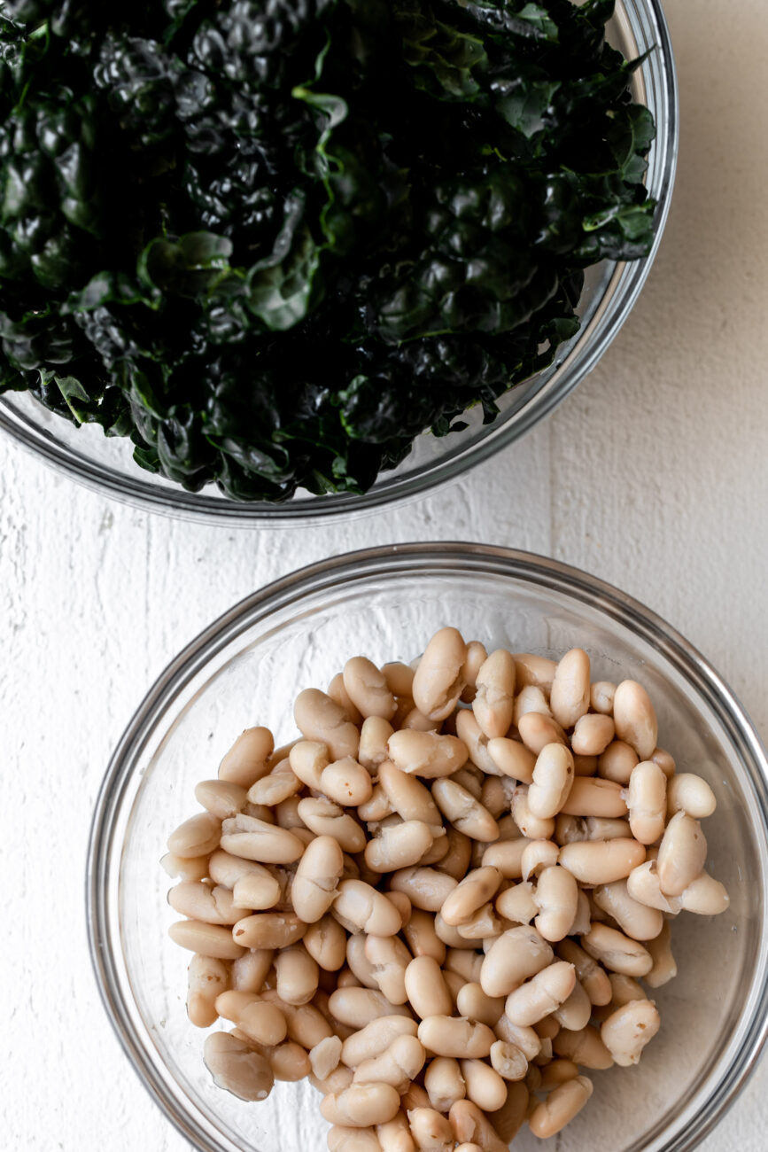 tuscan kale and white beans in bowls.