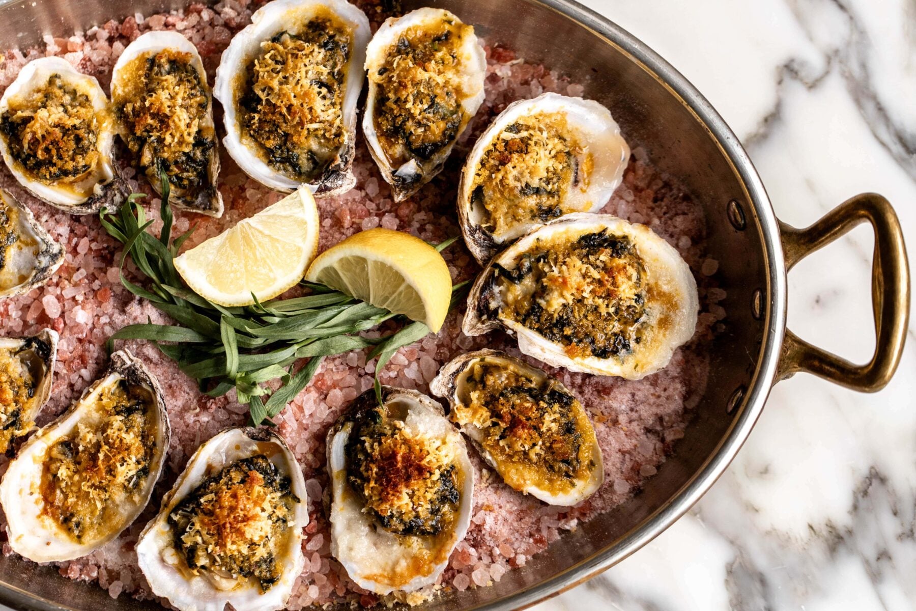 baked oysters rockefeller shellfish on the half shell with pink rock salt.