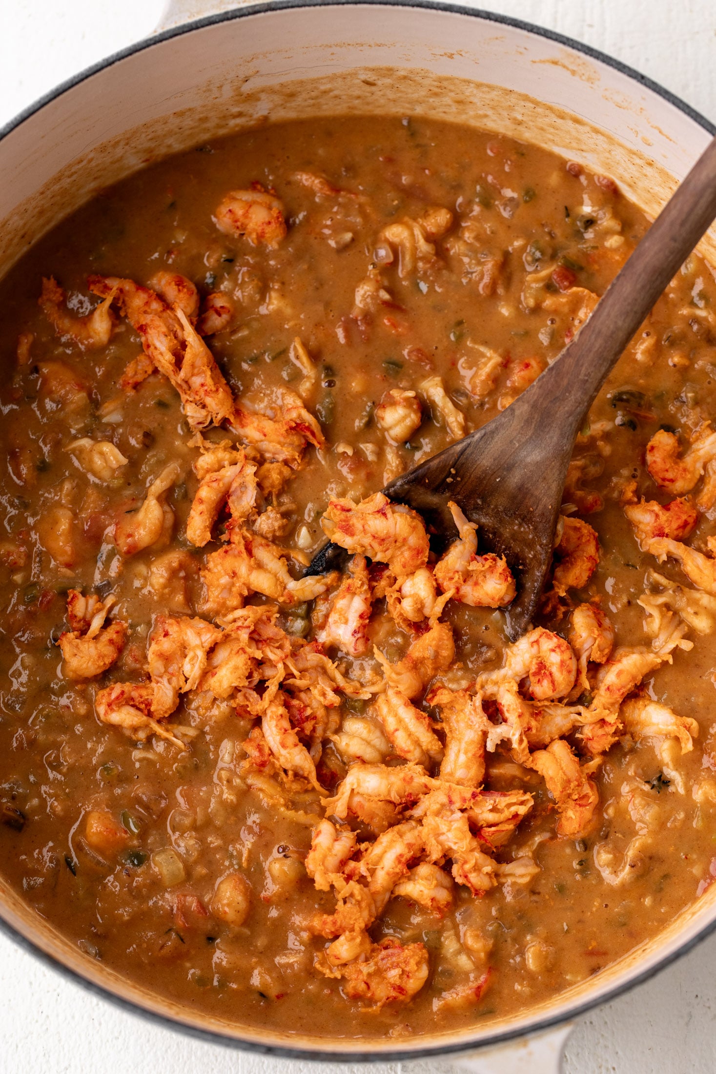 crawfish étouffée simmered in pot with crawfish bodies. 