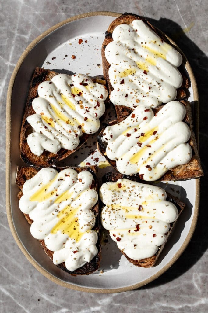 whipped ricotta piped onto toasts with a drizzle of olive oil.