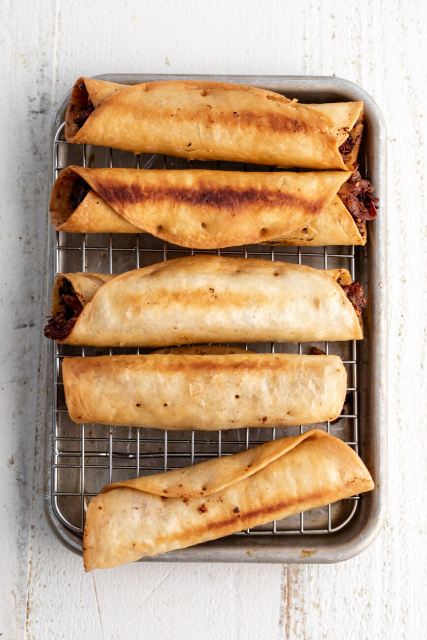 flautas draining on baking rack.