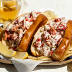 new england style lobster rolls in brioche buns with chips.