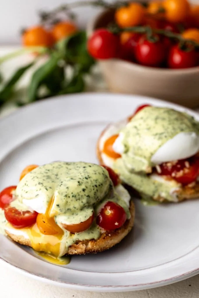 toasted English muffins with fresh mozzarella, marinated cherry tomatoes, poached eggs, and basil-infused hollandaise sauce