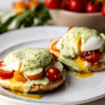 caprese eggs benedict with marinated tomatoes and mozzarella.