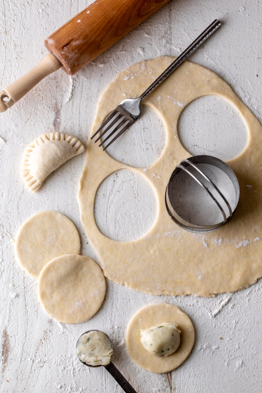 rolled out pierogi dough with cutout.