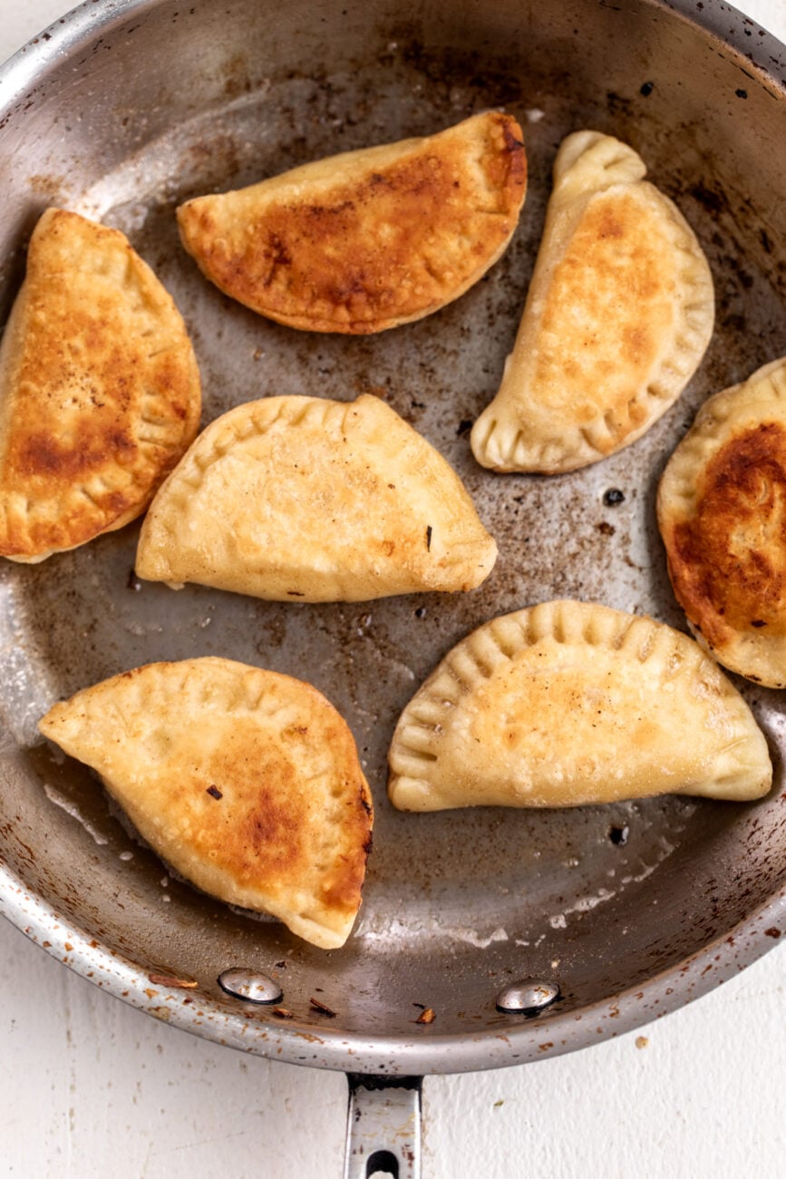 pan-fried pierogi in sauté pan.