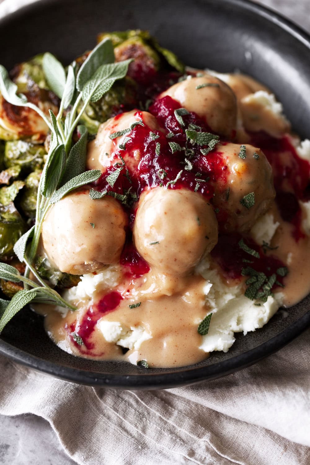Finished and plated Thanksgiving Turkey Meatballs with Gravy & Red Wine Cranberry Sauce.