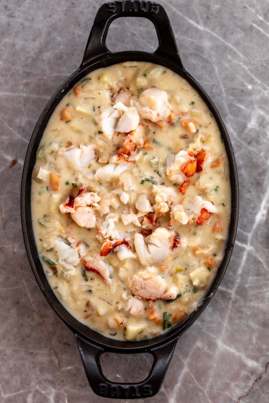 oval baking dish with lobster pot pie filling.