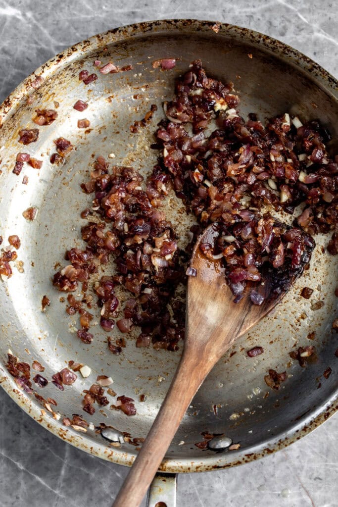 red onion caramelized in pan with ginger and lemongrass.