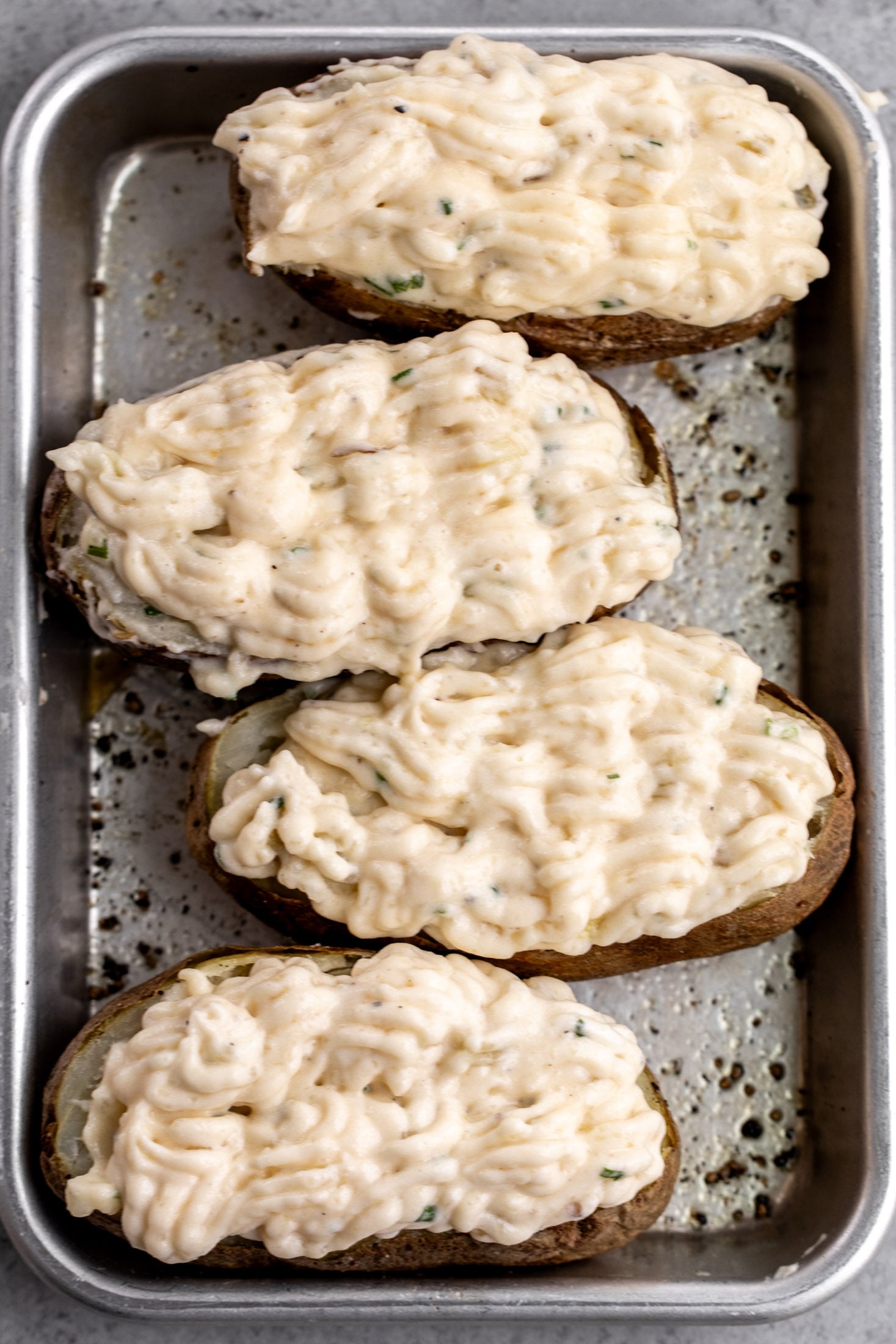 piped potato filling into scooped out potatoes.