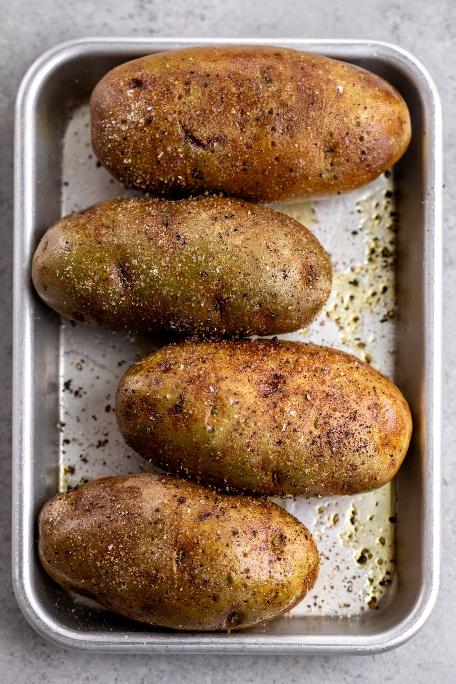 russet potatoes rubbed with olive oil and seasoned with salt and pepper.