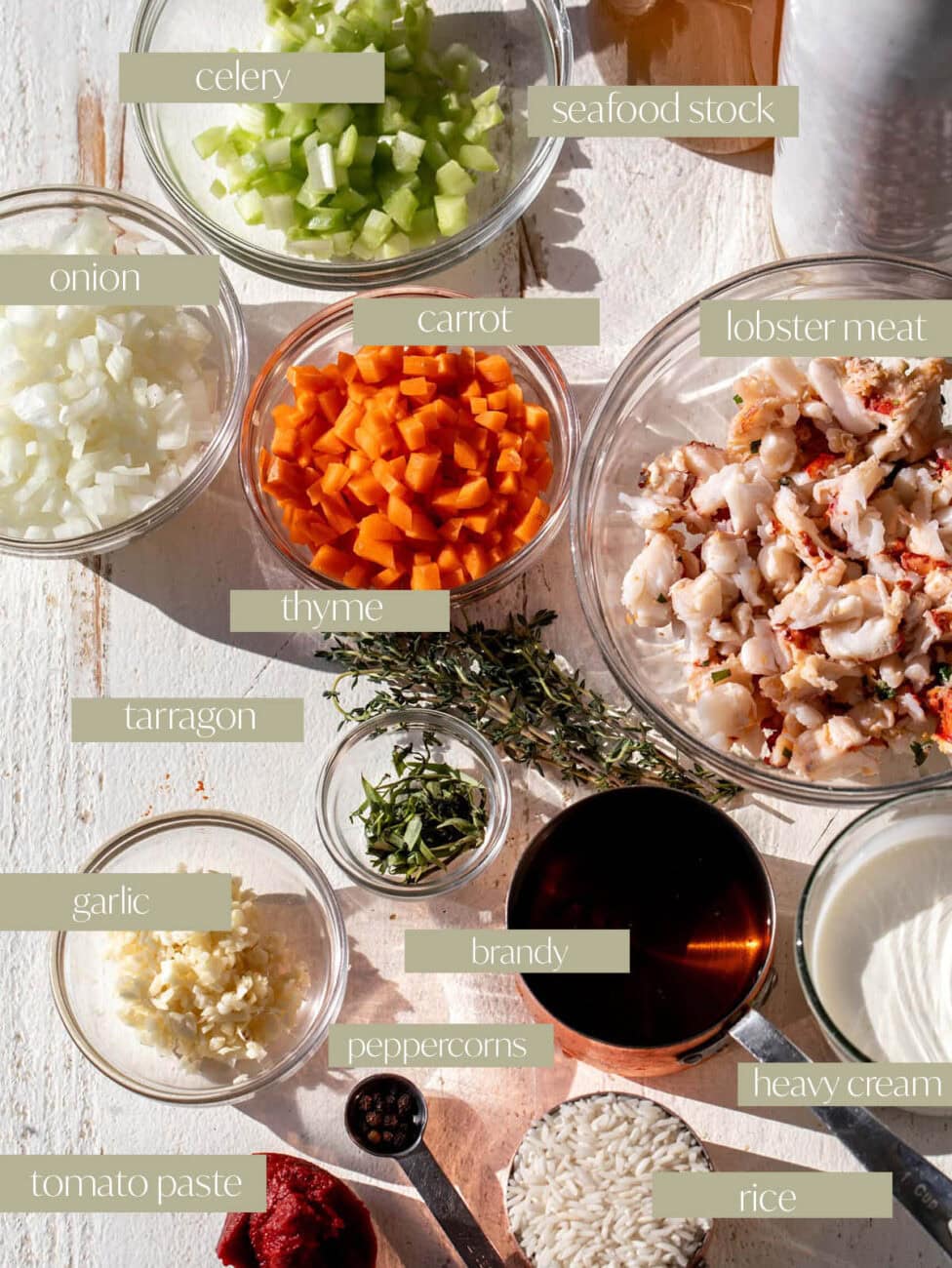 ingredients for lobster bisque laid out in bowls flatlay.