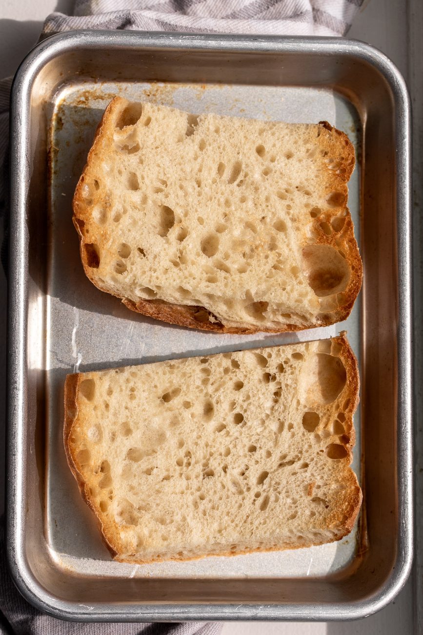toasted ciabatta bread on baking sheet.