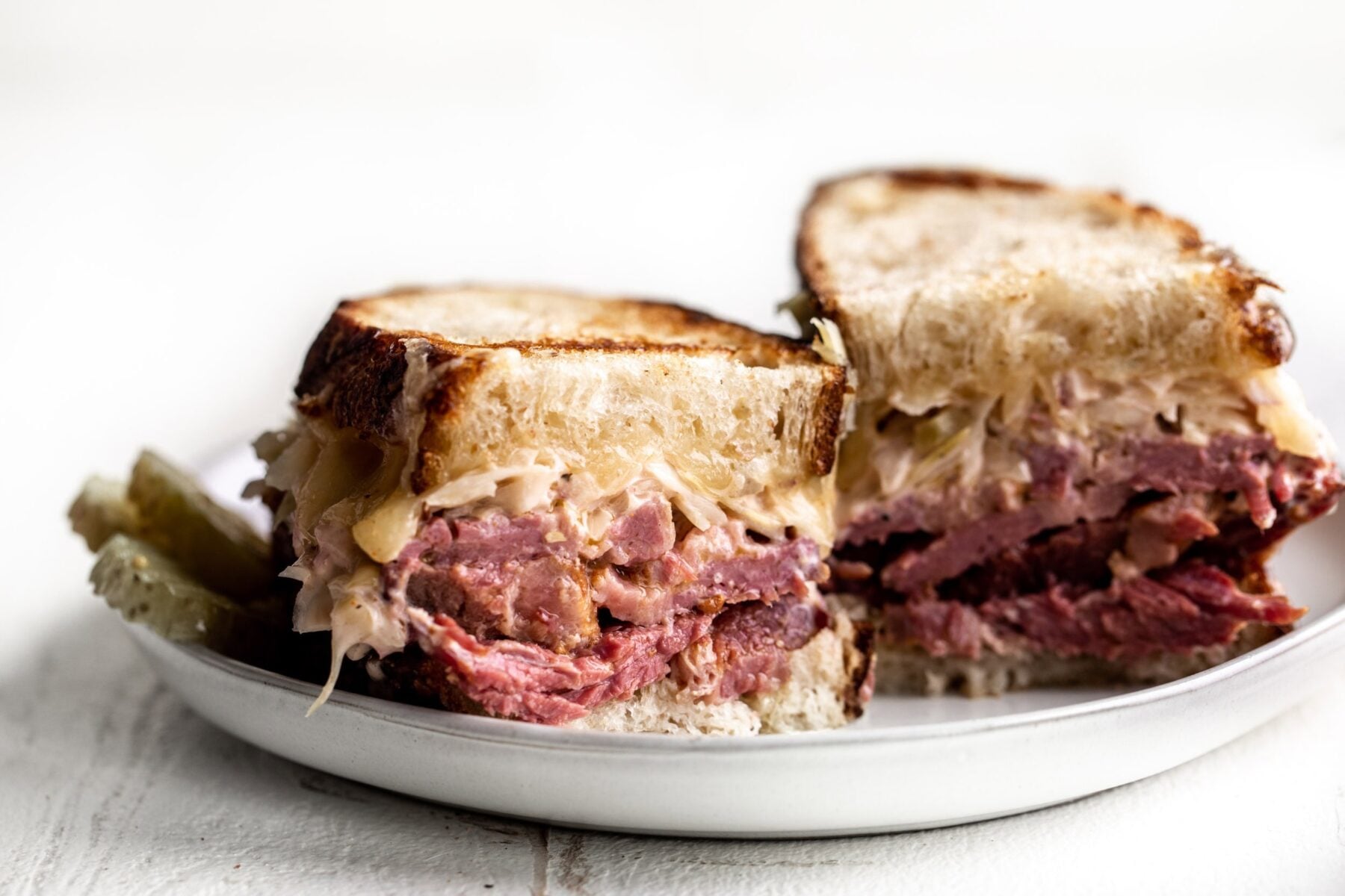 Corned beef reuben sandwich on a plate.