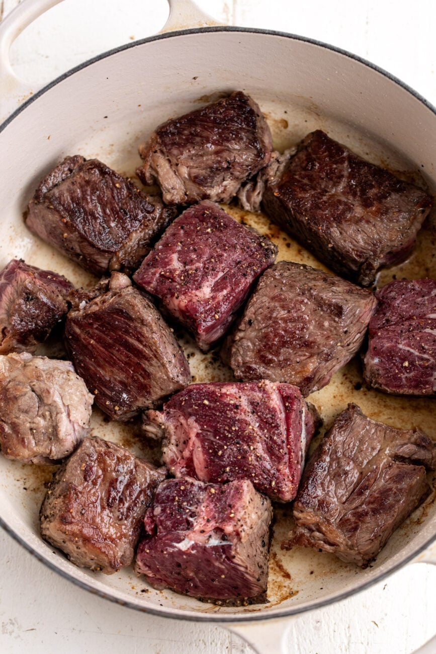 cubed boneless short rib beef seared in pot.