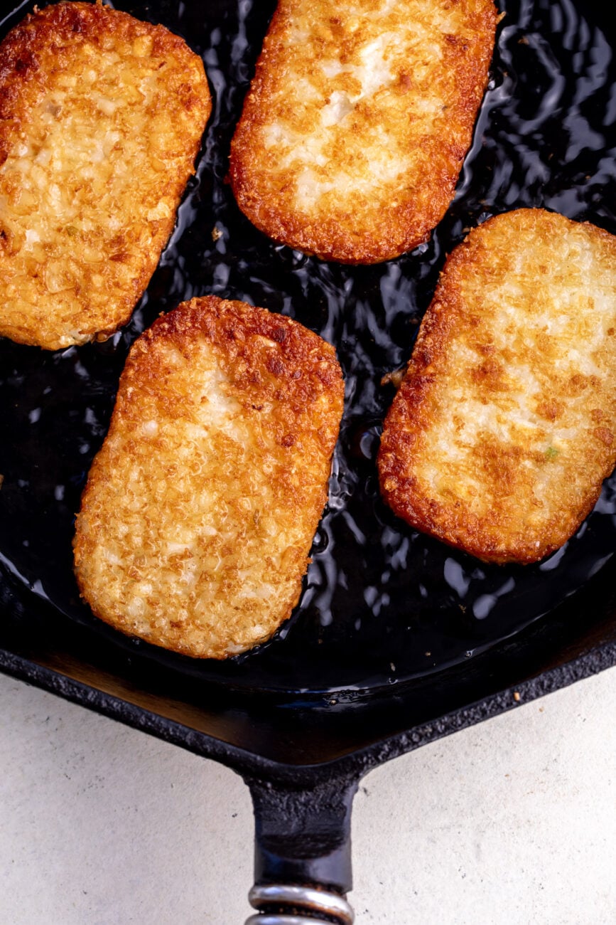frozen hash browns fried in vegetable oil in cast iron pan.