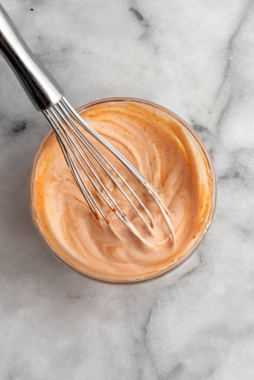 sriracha yogurt sauce with whisk.