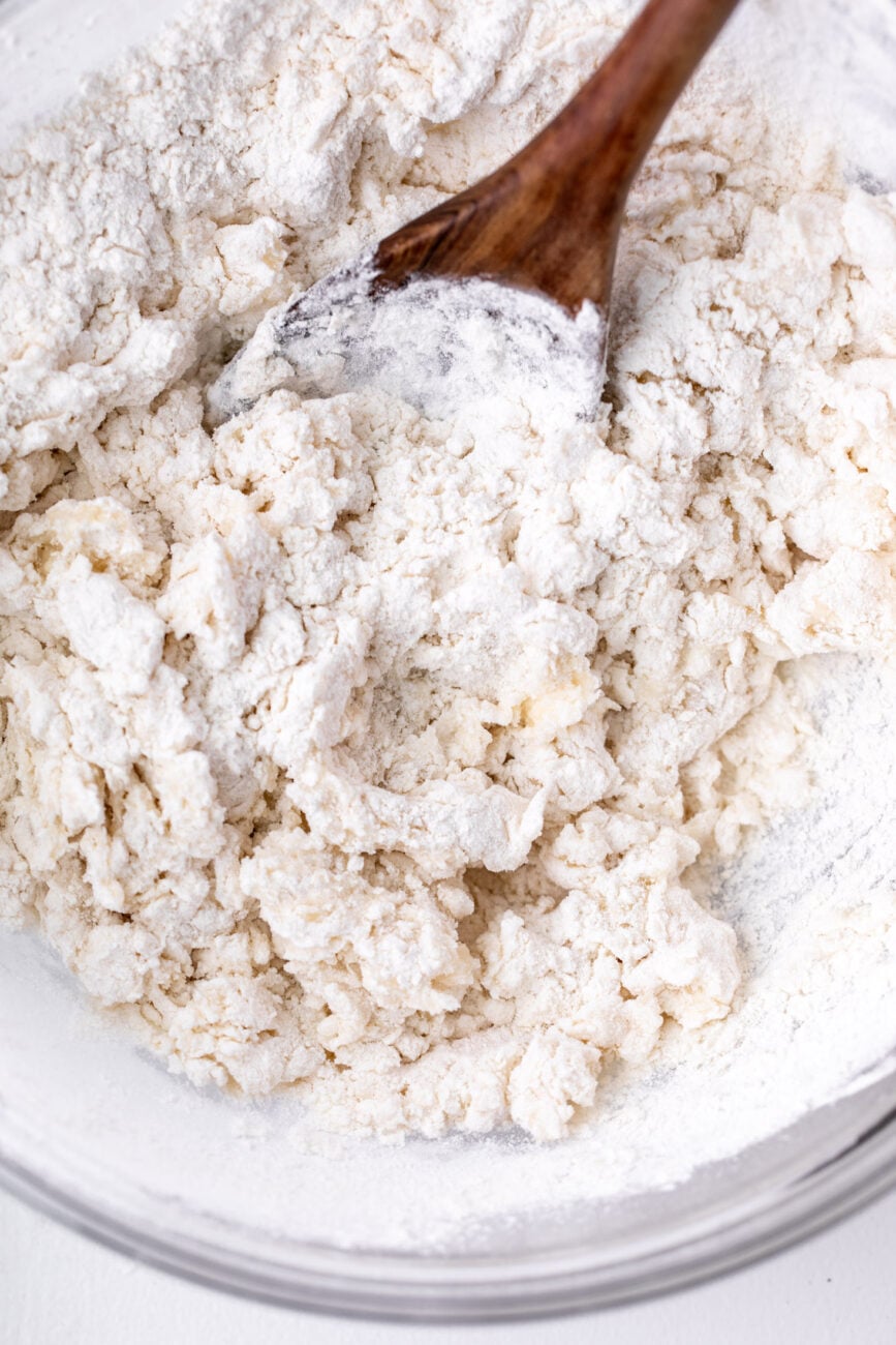 mixing flour and hot water to make homemade dumpling dough.