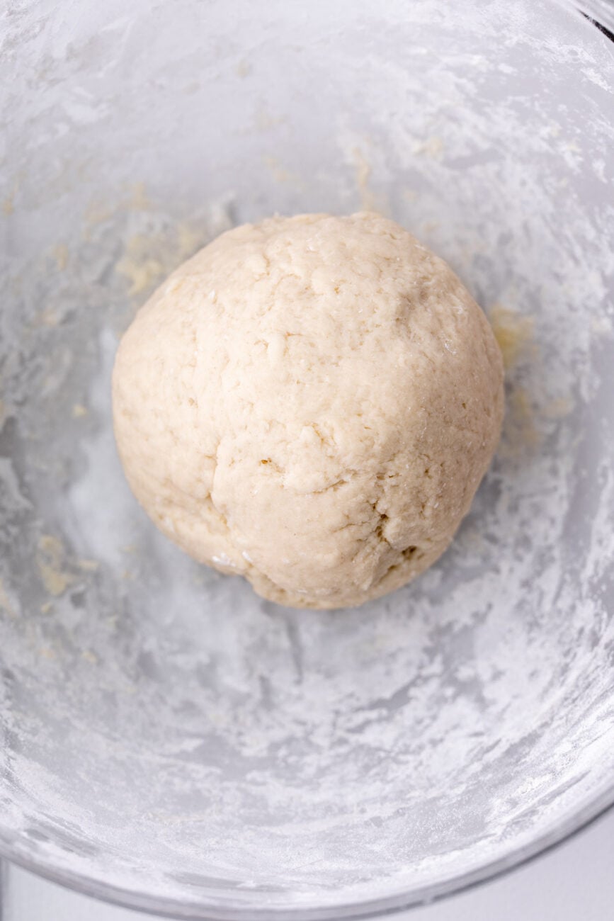 dough ball rested in glass bowl.