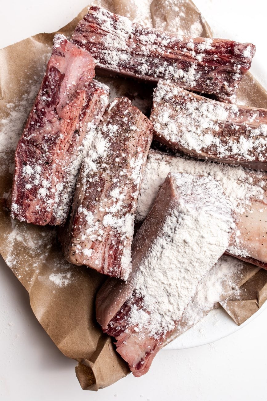 seasoned beef short ribs dusted with flour.