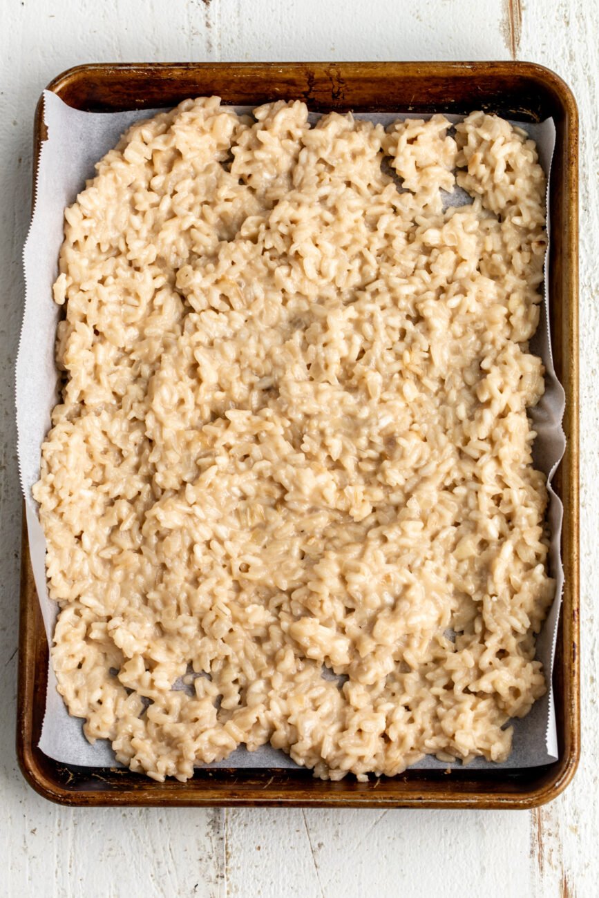 Cooked risotto spread on baking sheet to cool.