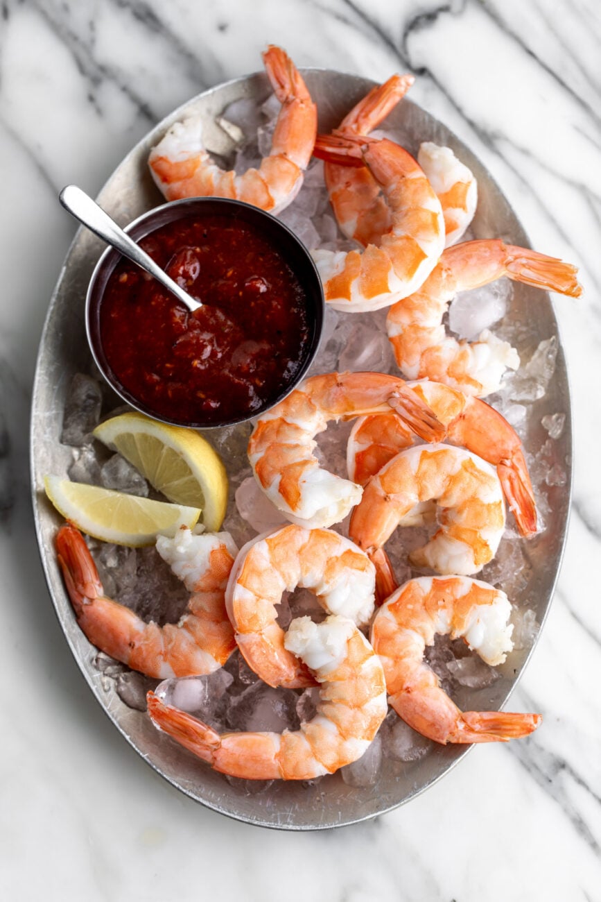 shrimp cocktail with lemon wedges.