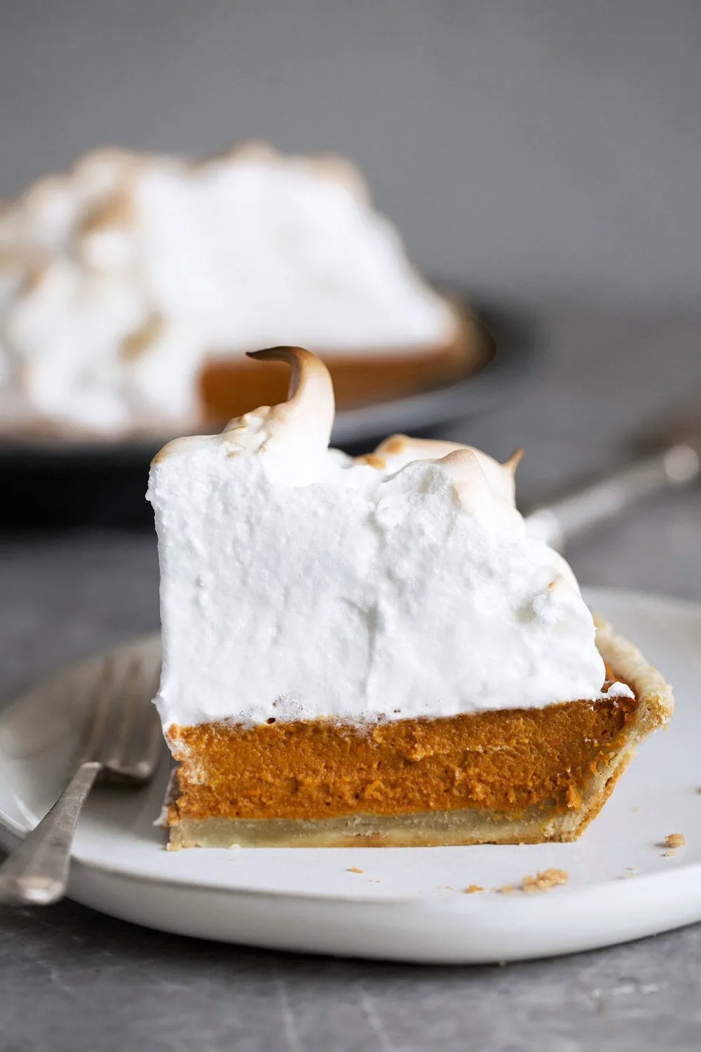 Sweet Potato Pie with Toasted sky high Meringue Topping slice on plate with fork 