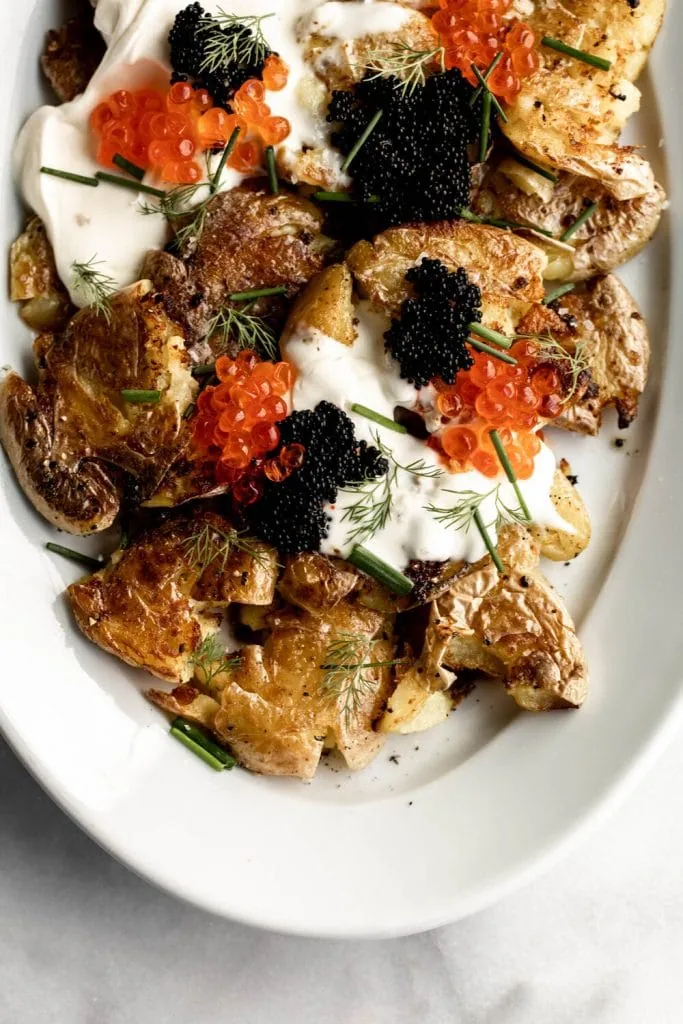  Crispy Smashed Fried Potatoes topped with caviar and salmon roe chives and dill