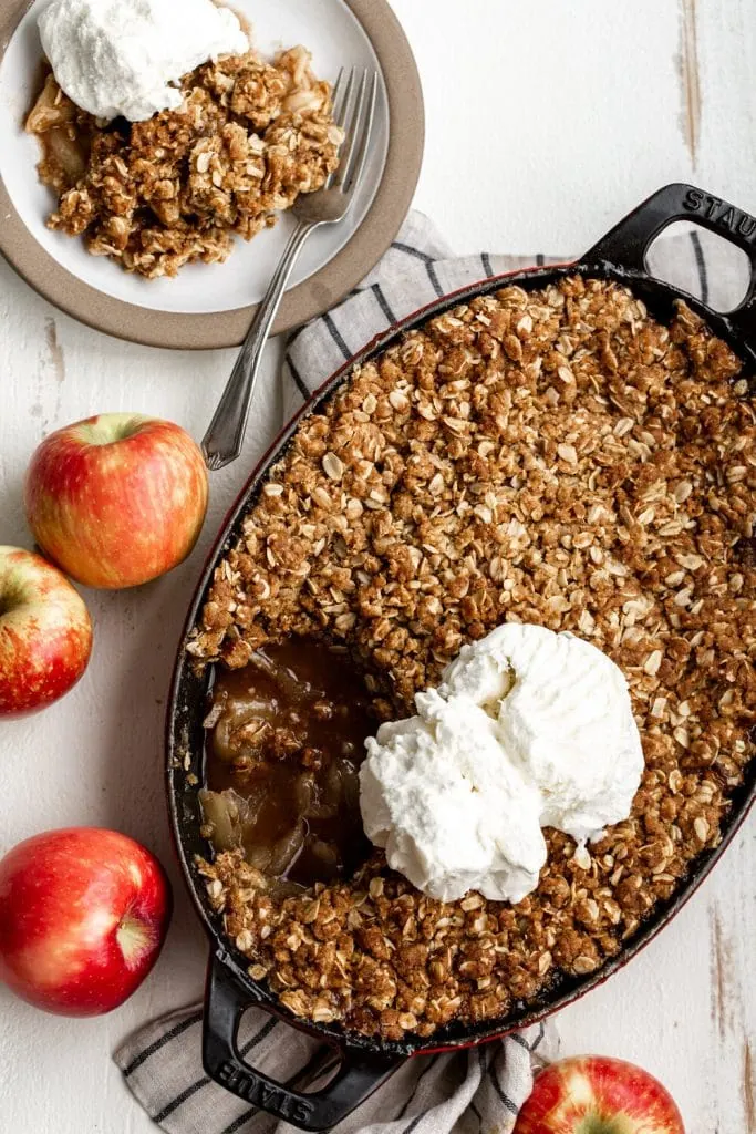 Apple Crisp Recipe with oat topping with serving scoop of vanilla ice cream.