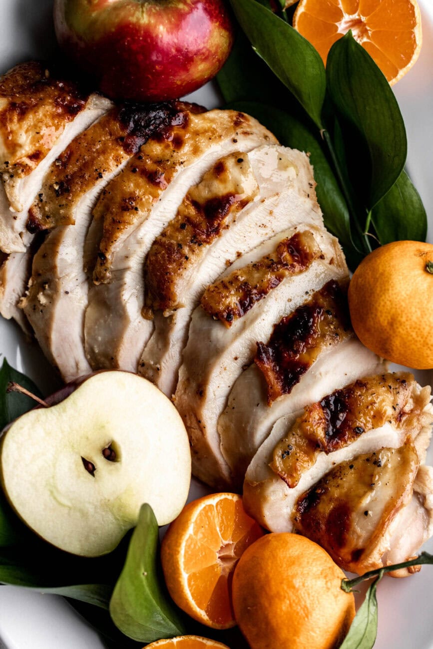 Apple Cider Brined Turkey Breast for Two sliced and garnished with apples.