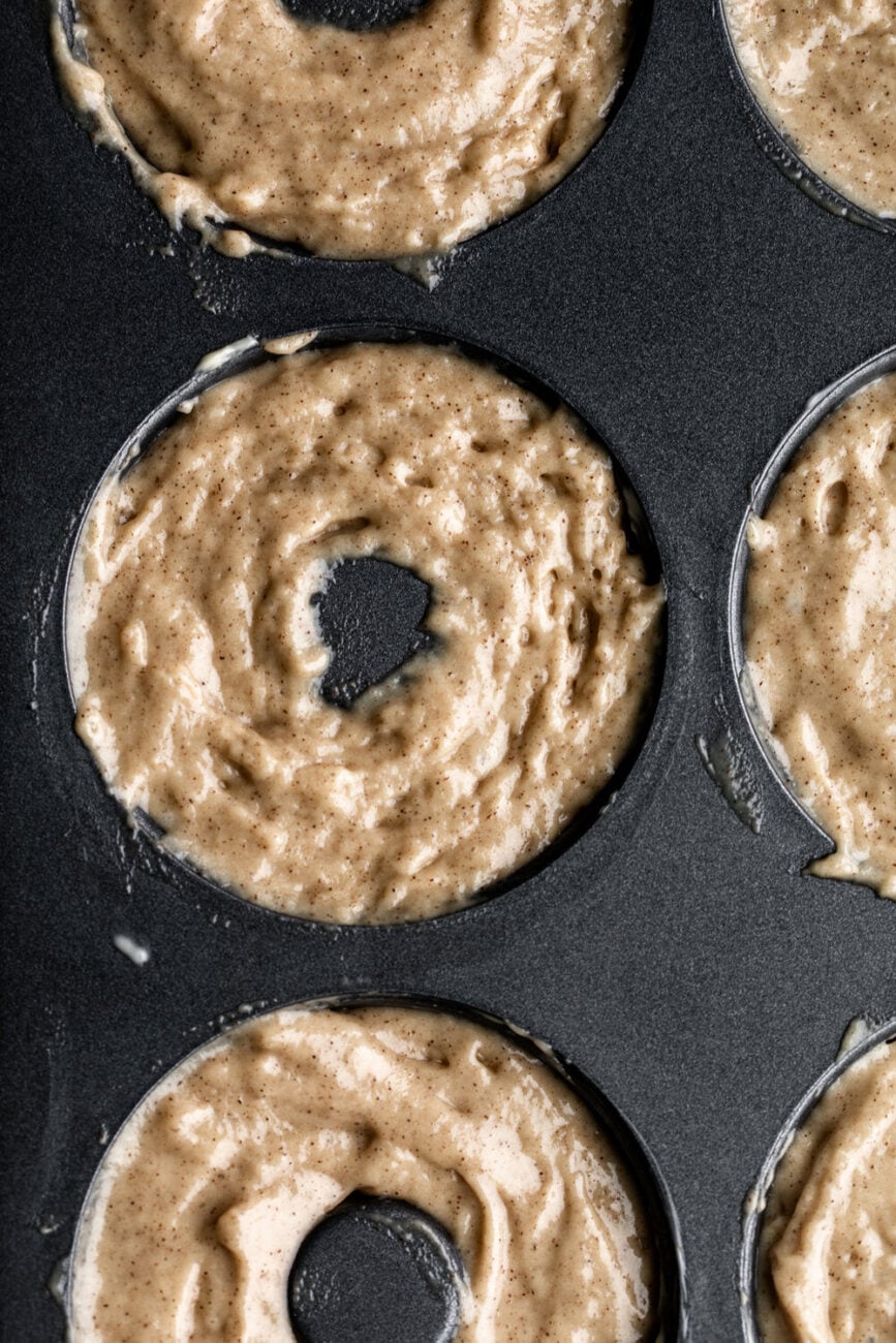 baked cider donuts batter in donut pan.