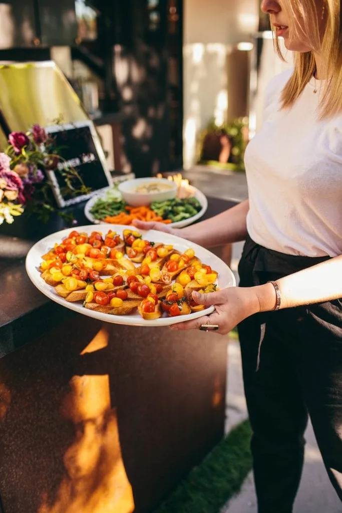 Kylie Mazon-Chambers serving food for The South of Italy inspired 