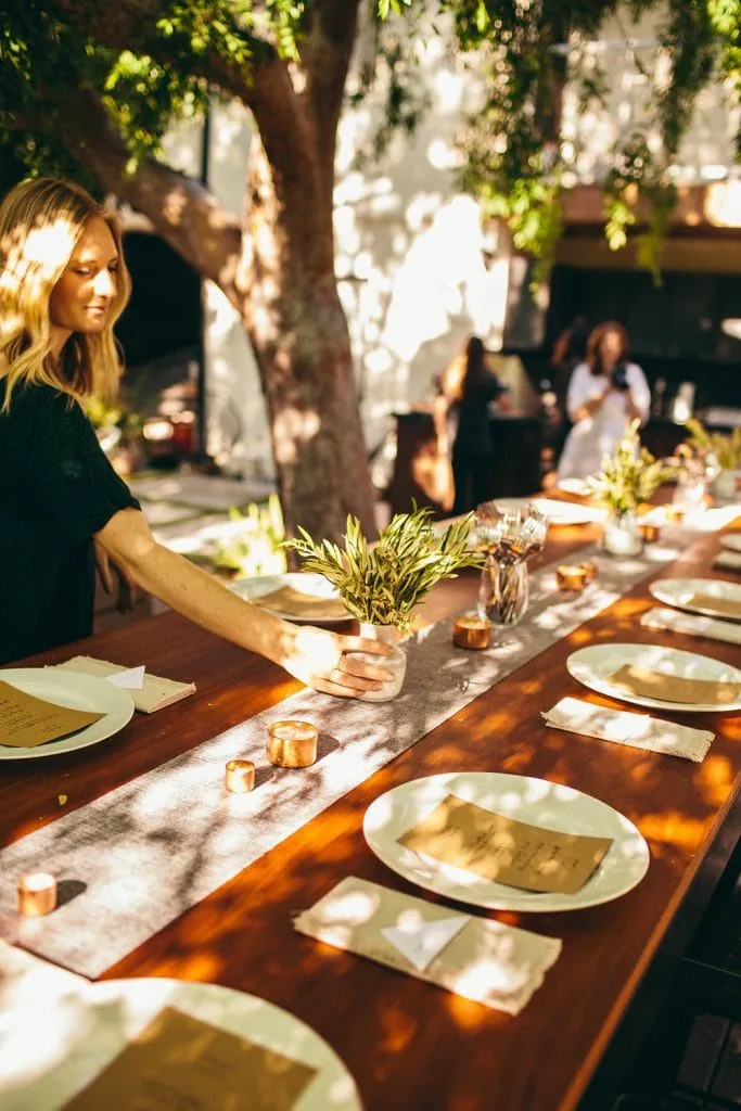 woman arranging the table for The South of Italy inspired 