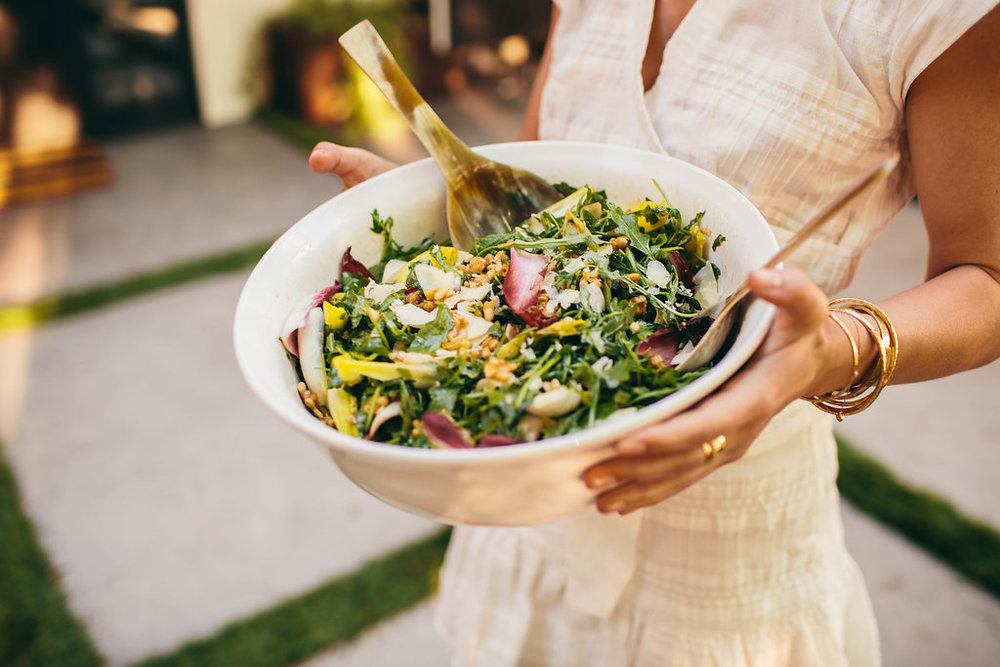 woman holding a bowl of salad for The South of Italy inspired 