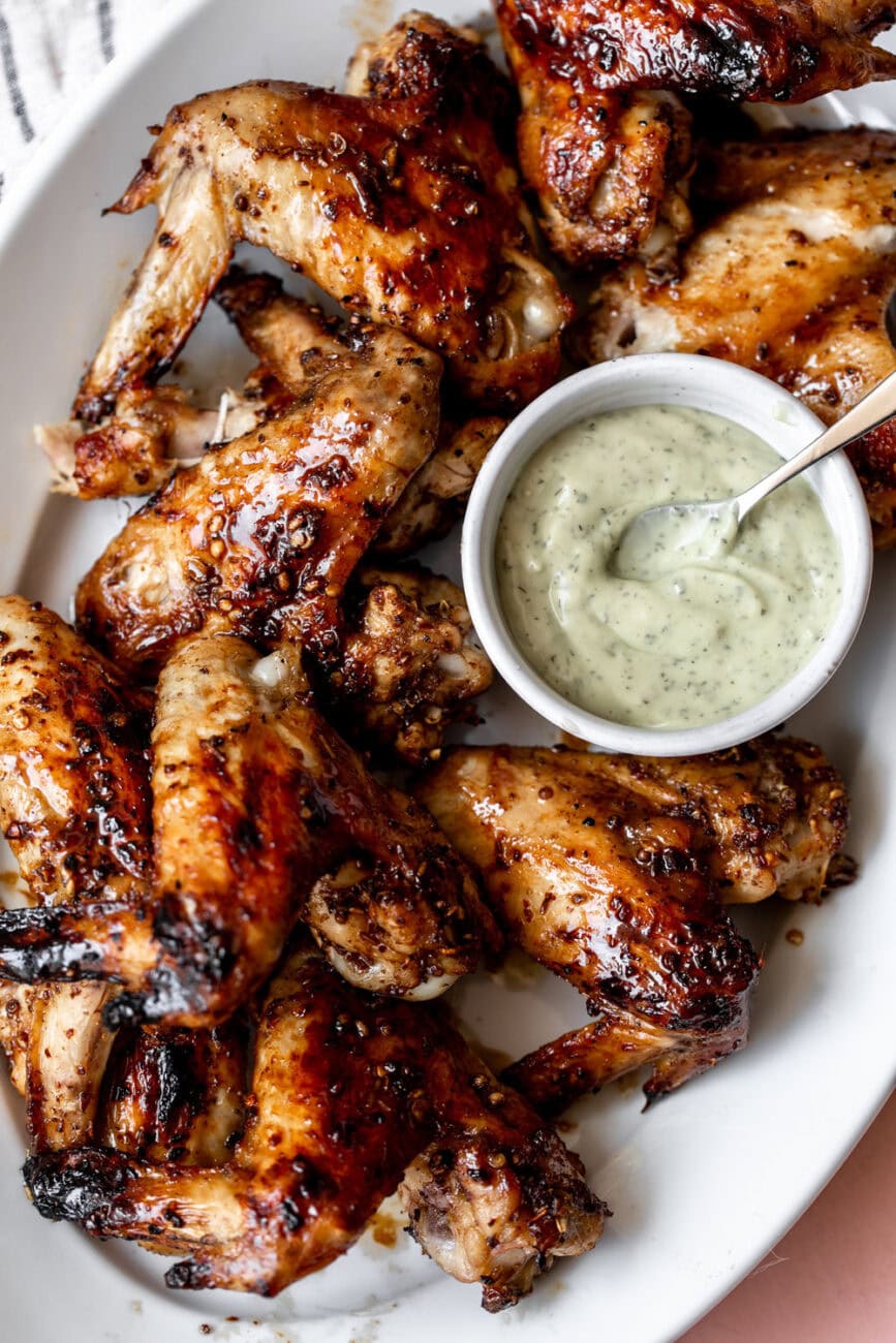 Baked fiery sichuan peppercorn chicken wings with avocado ranch sauce.