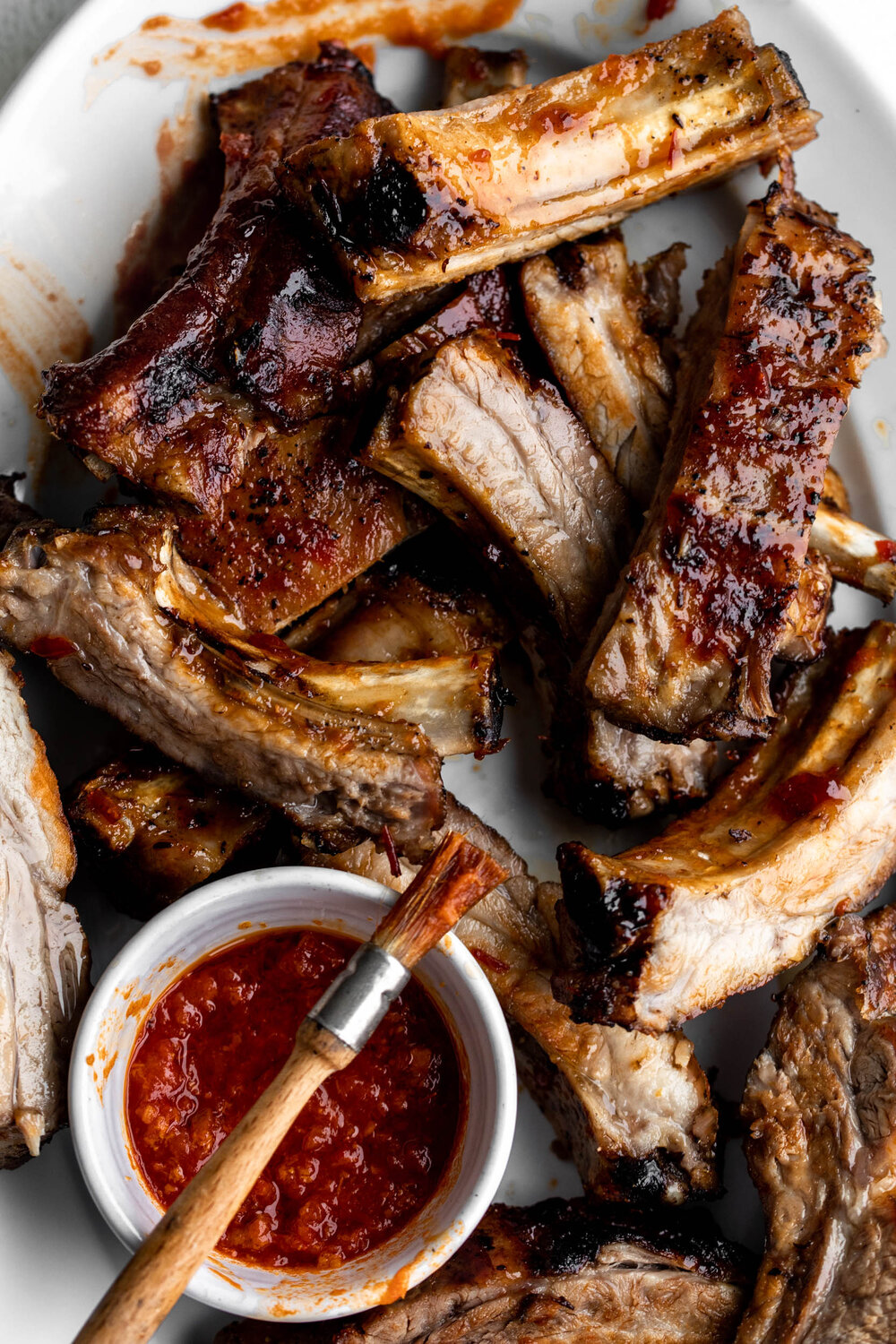 baked sticky honey harissa pork ribs on plate