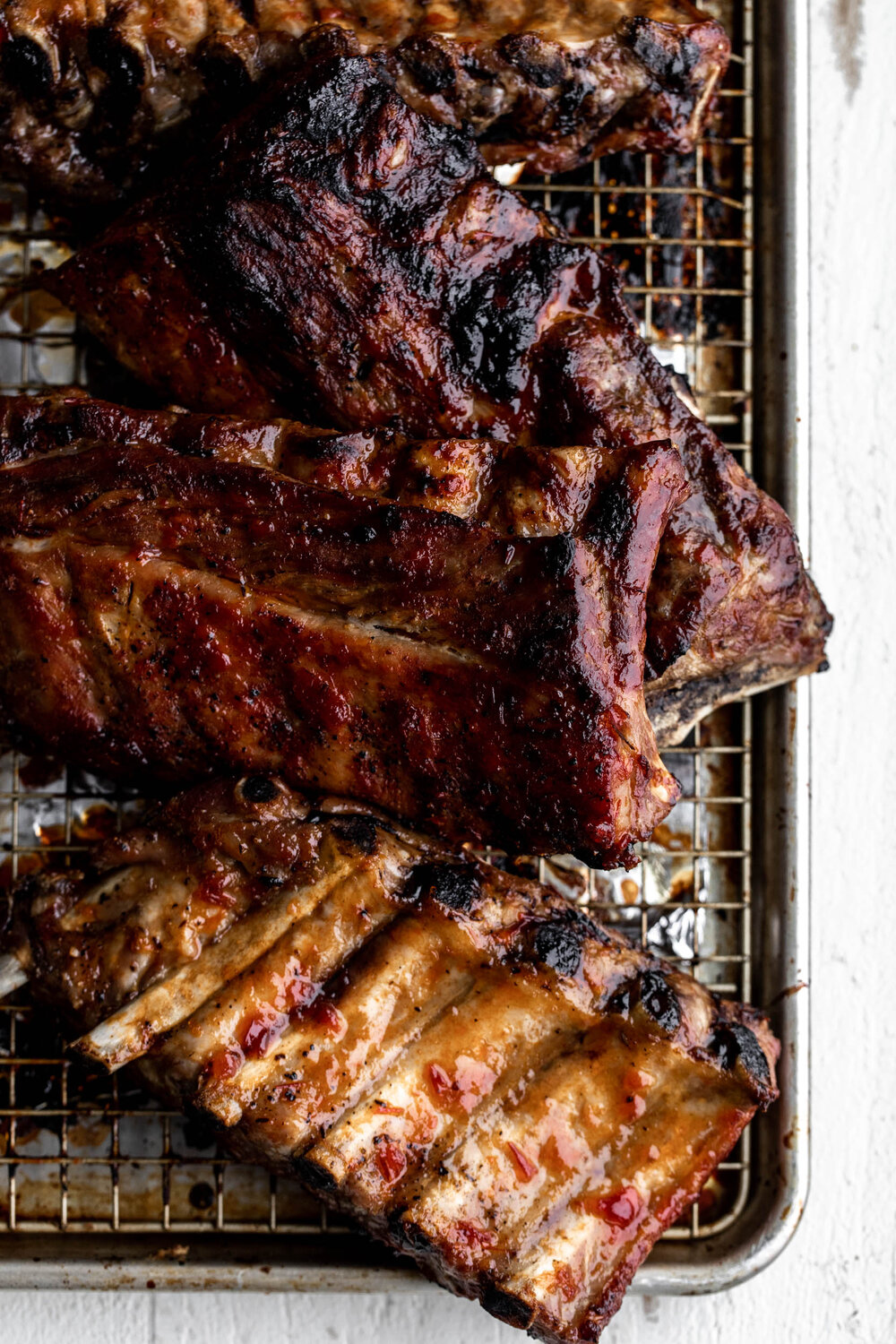 baked pork ribs on wire rimmed baking sheet 