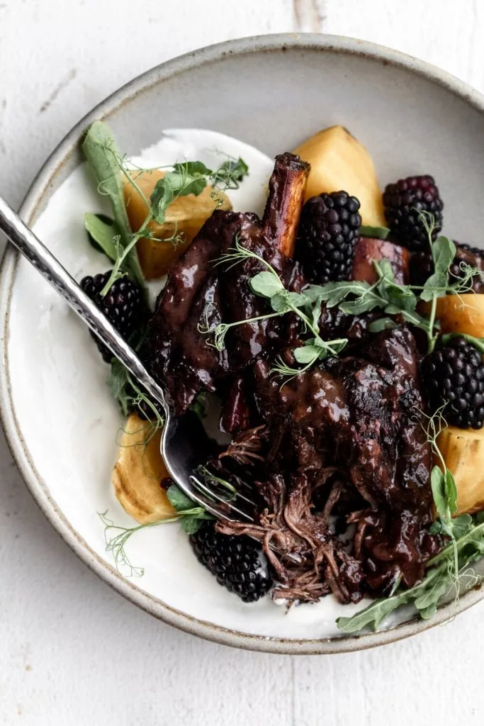 Blackberry Short Ribs with Whipped Ricotta and Roasted Beets in ceramic bowl.