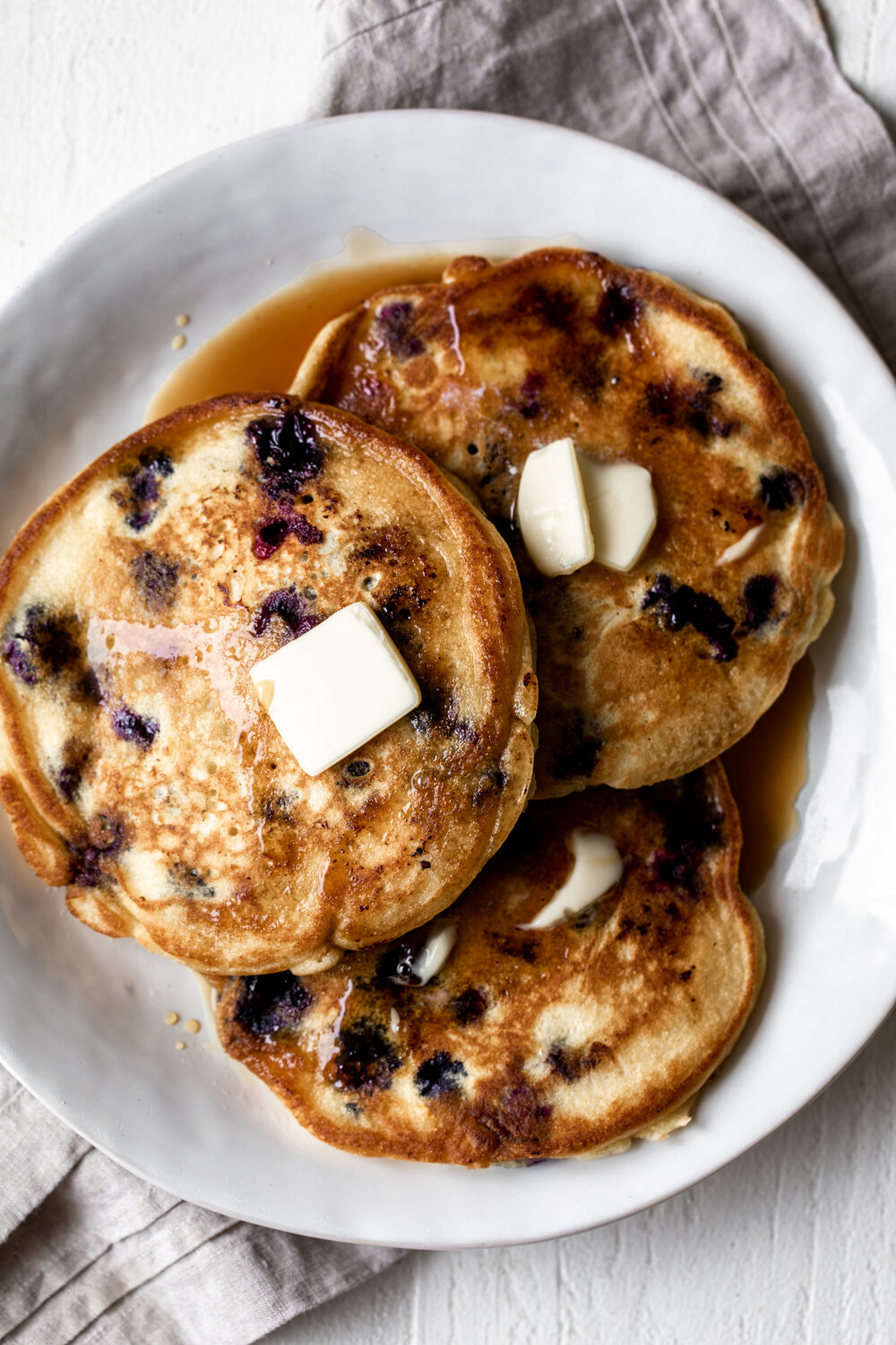 These blueberry pancakes are made with equal parts cornmeal and flour and loaded with juicy blueberries for a delicious summer breakfast.
