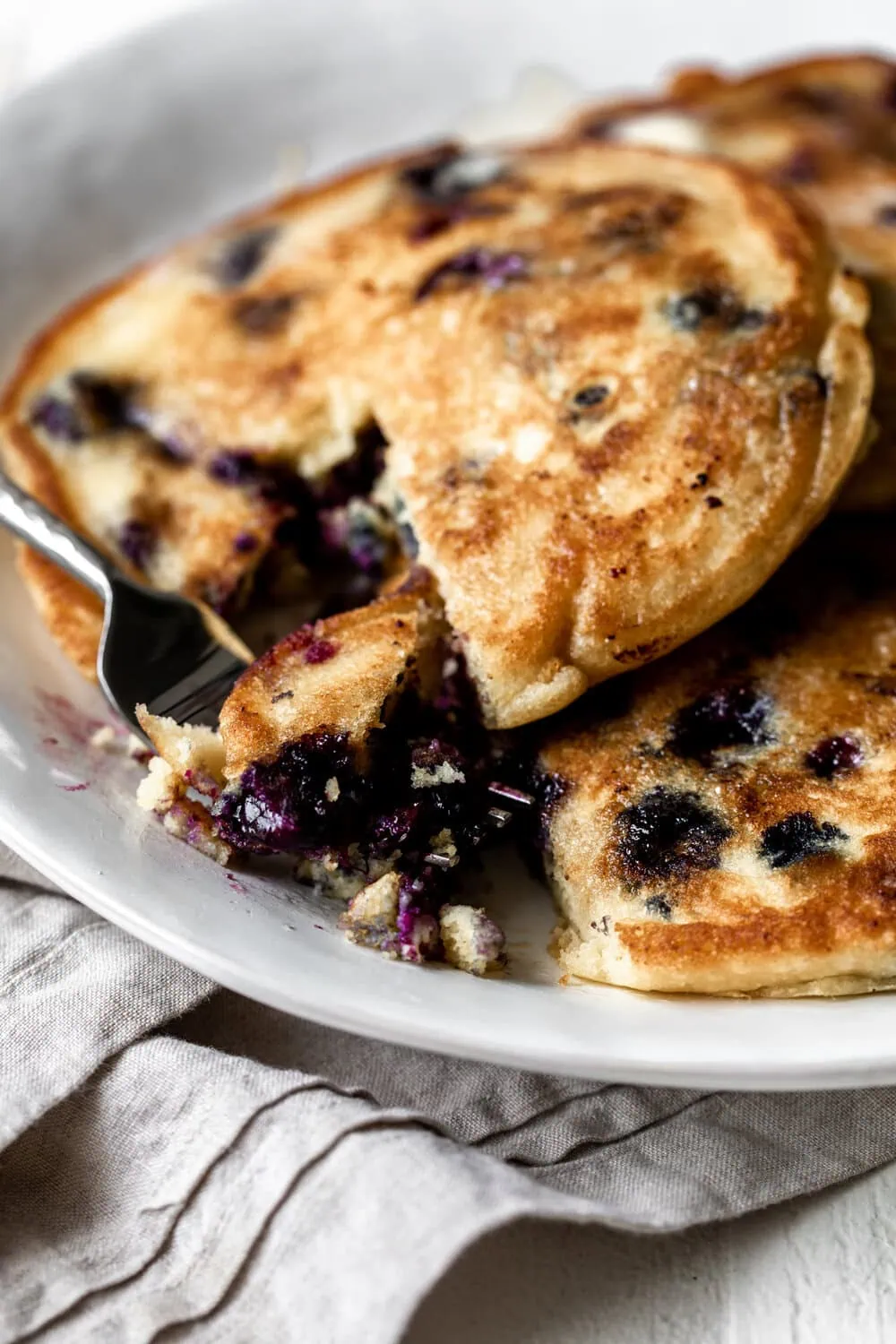 Blueberry Cornmeal Pancakes cut with fork