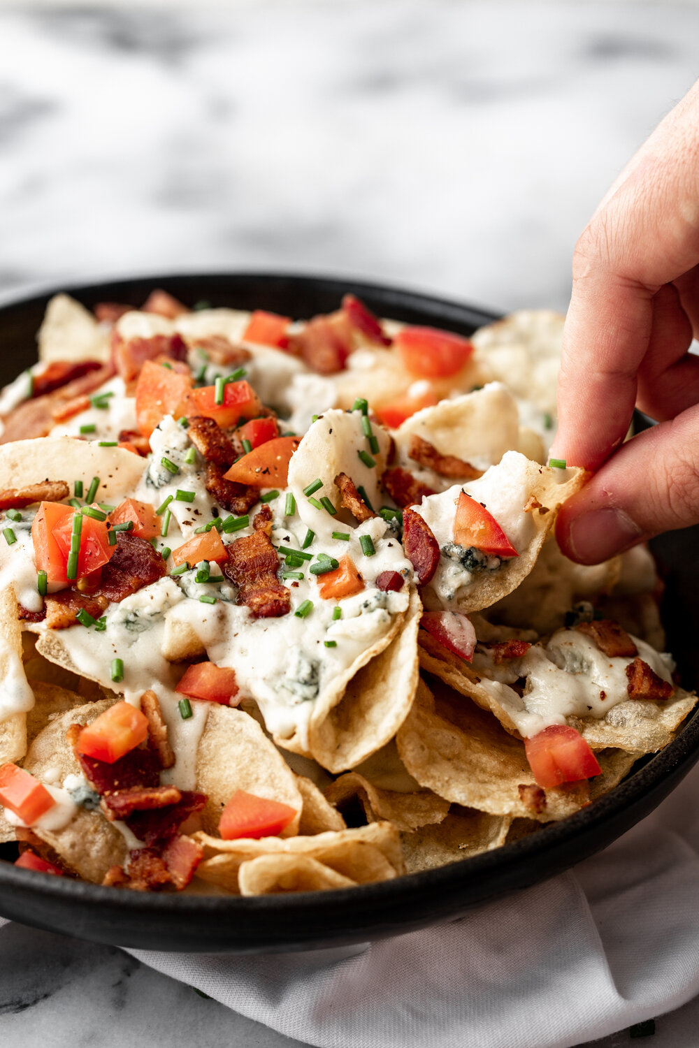 Blue cheese chips topped with tomatoes and bacon