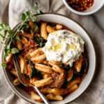 Braised Pork Ragù over Cavatelli with Burrata and garnish of oregano.