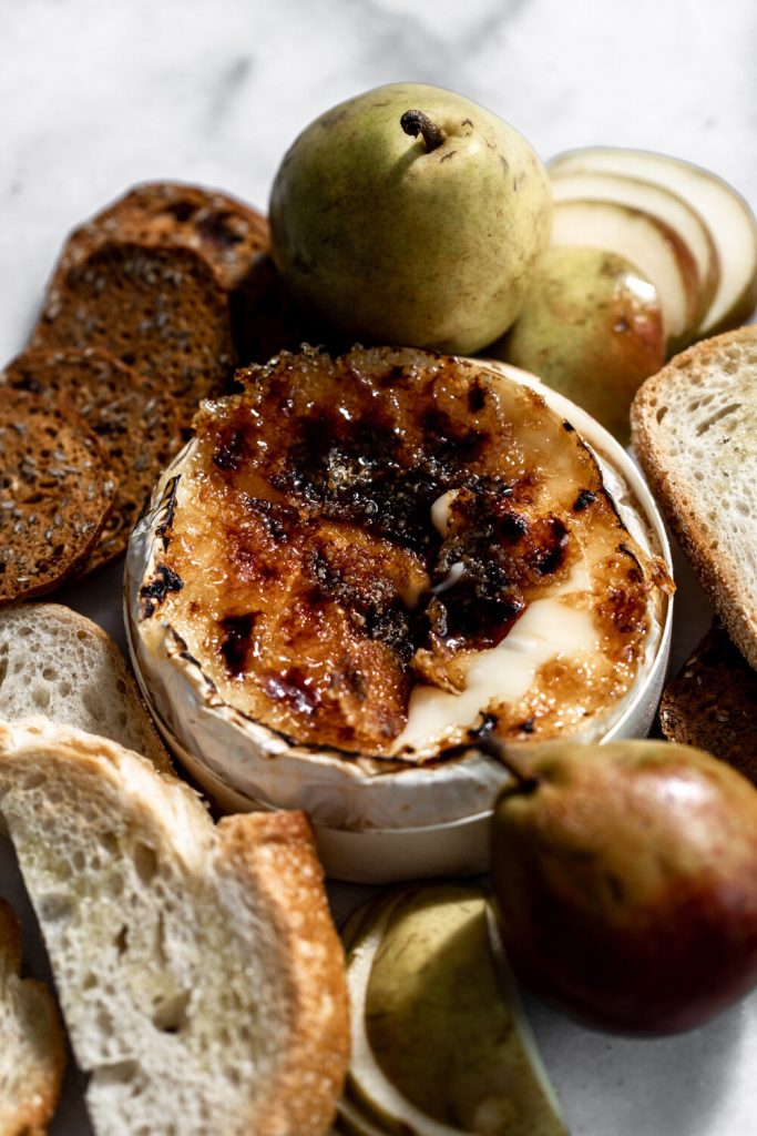 Brie Brûlée with grilled bread and pears