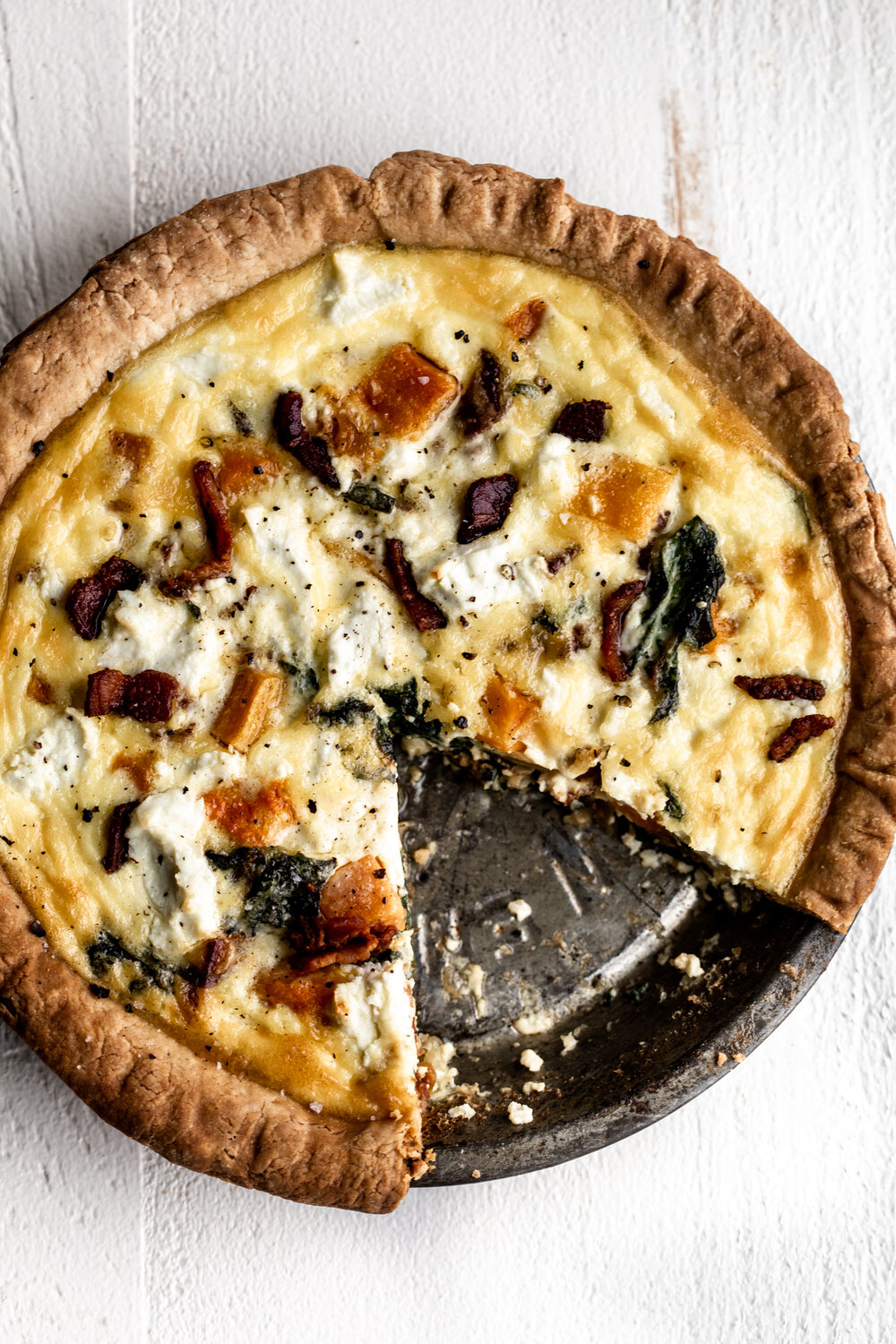 Butternut Squash, Chard and Bacon Quiche in pan with goat cheese